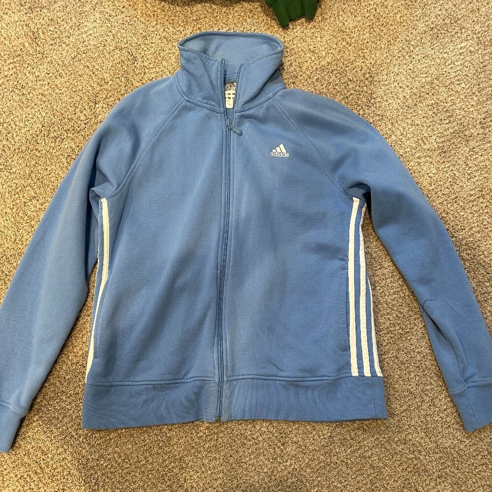 Blue Adidas zip-up jacket.